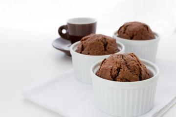 Chocolate muffins in classic ramekins  on white background