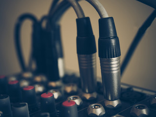 Microphone connectors pluged in a audio music mixing console. Vi