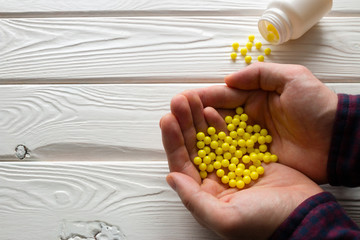 man holding ascorbic acid in the palms