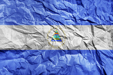 Nicaragua flag painted on crumpled paper background
