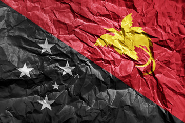 Papua New Guinea flag painted on crumpled paper background