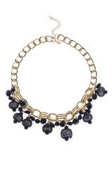 gold necklace with black beads on a white background
