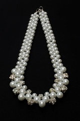 pearl necklace on a black background