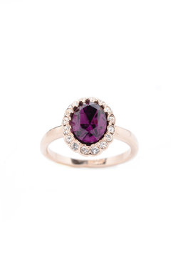 ring with purple stone on white background
