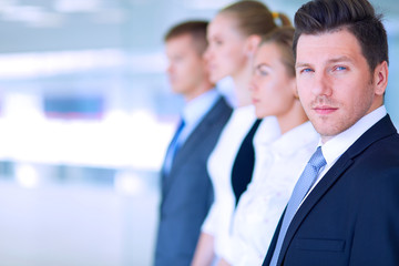 Smiling successful business team standing in office
