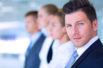 Smiling successful business team standing in office