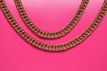 gold chain on a pink background
