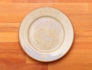 Empty plate on a wooden table. Background for your menu.