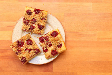 Pieces of honey cake with cherries. Traditional summer sweets from Czech countryside.