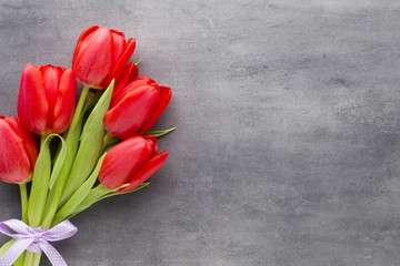 Red tulips on a wooden background.