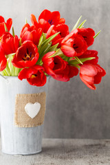 Red tulips on a wooden background.
