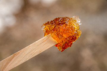 Maple taffy on a stick during sugar shack period