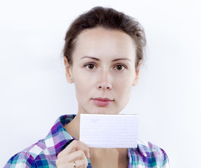 A beautiful casual young woman holding a blank business card in