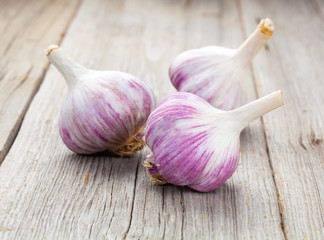 Organic garlic whole and cloves on the wooden background