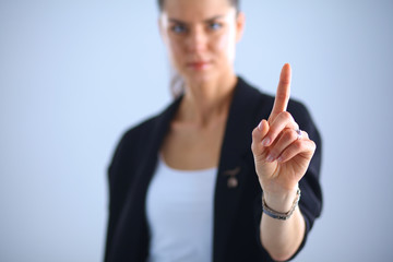 Woman touching an imaginary screen with her finger 