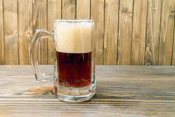 cup of beer on wood