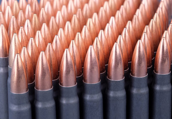 Live ammunition for automatic weapons or rifles ranked diagonally closeup.