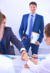Business people shaking hands, finishing up a meeting, in office