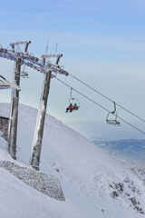 Chair lifts with people in Kasprowy Wierch in Zakopane in winter