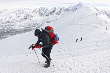 Fototapeta na wymiar Man climbing on Kasprowy Wierch in Zakopane on Tatras in winter