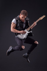 Fototapeta premium Attractive male guitarist with a cool musical instrument