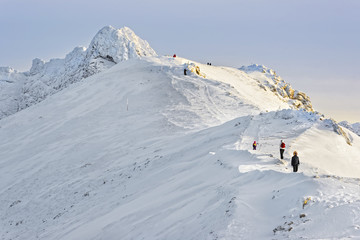 Fototapeta na wymiar People climbing at the top of Kasprowy Wierch of Zakopane in winter