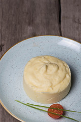 Mashed potatoes with cherry tomatoes on a plate