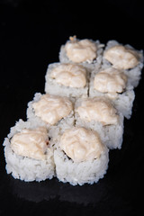 Sushi rolls on a black background, Japanese cuisine