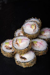 Sushi rolls on a black background, Japanese cuisine