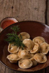 Ravioli with sauce and greens on a plate