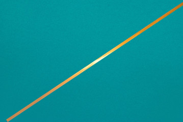 golden line on color paper background - abstract graphic design