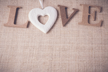 "Love" word on linen background, selective focus, toning.