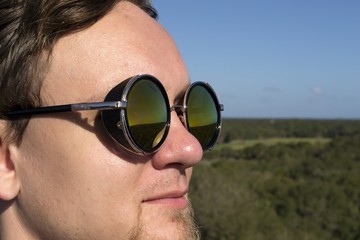 Man in round green dark sunglasses - goggles