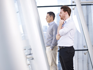 Fototapeta premium businessmen looking out of window