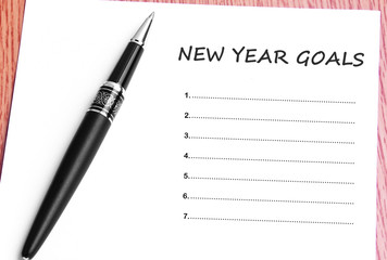 Pen  and notes paper with new year goals