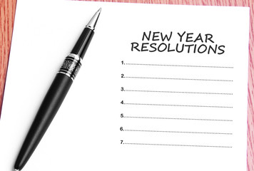 Pen  and notes paper with new year resolutions