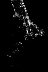 Abstract splashes and drops of water on black background.