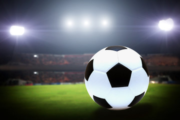 Naklejka na ściany i meble Soccer Ball On Green Field of football stadium for background