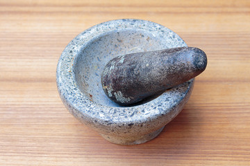 stone mortar  On the wooden floor background