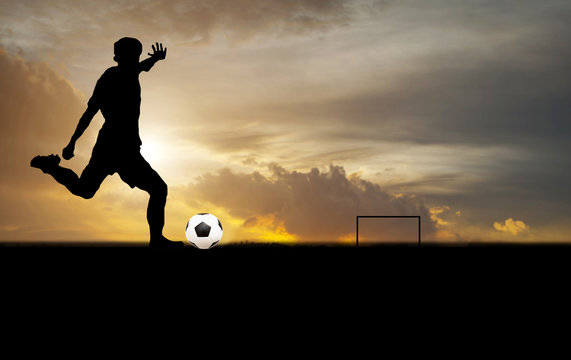silhouette of a player shooting football on goal at the outdoor © tuiphotoengineer