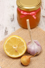 Onion, garlic, lemon and honey in glass jar, healthy nutrition and strengthening immunity