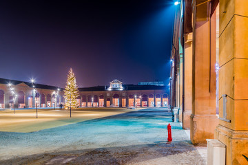 Christmas tree in square surrounded by loggias