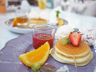 Pancakes with fruits and strawberry sauce