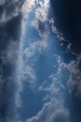 Fototapeta premium sunbeam through the clouds of sunlight in blue sky background