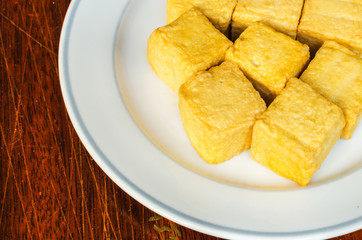 fish Tofu in the plate on a wooden table