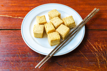 fish Tofu in the plate on a wooden table