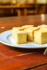 fish Tofu in the plate on a wooden table