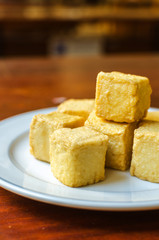 fish Tofu in the plate on a wooden table