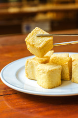fish Tofu in the plate on a wooden table