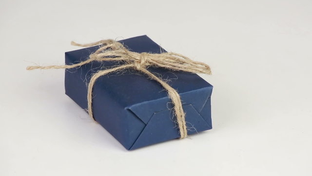 Gift box covered with blue wrapping paper